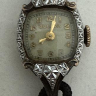 Front of watch. Black silk cord band