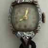 Front of watch. Black silk cord band
