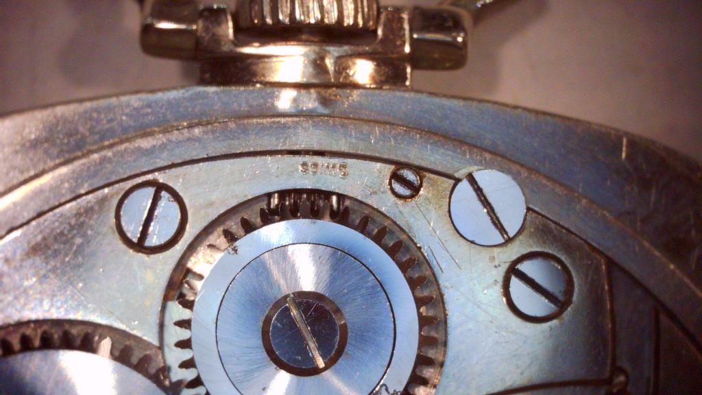 Between winding crown & gear