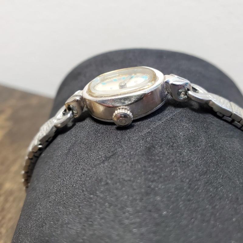 Right side of watch showing the crown with an engraved B