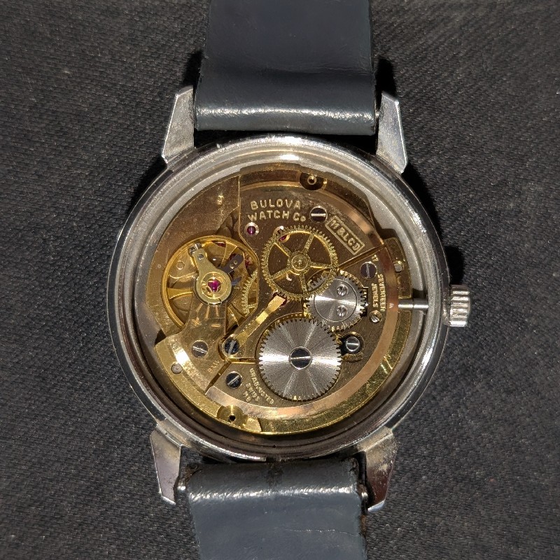 Back of watch with case back removed. Movement exposed. 