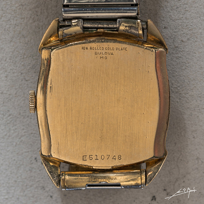 Detail of watch case back with serial number and date code