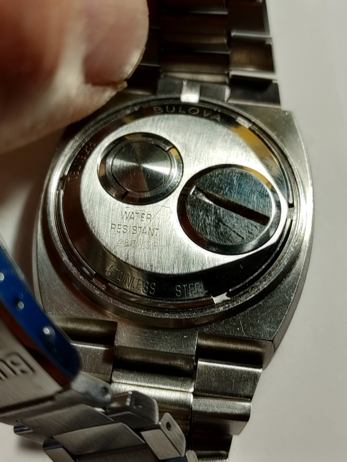 the back. Write "BULOVA", STAINLESS STEEL", "PATENTED", "WATER RESISTANT" and serial number "483406"