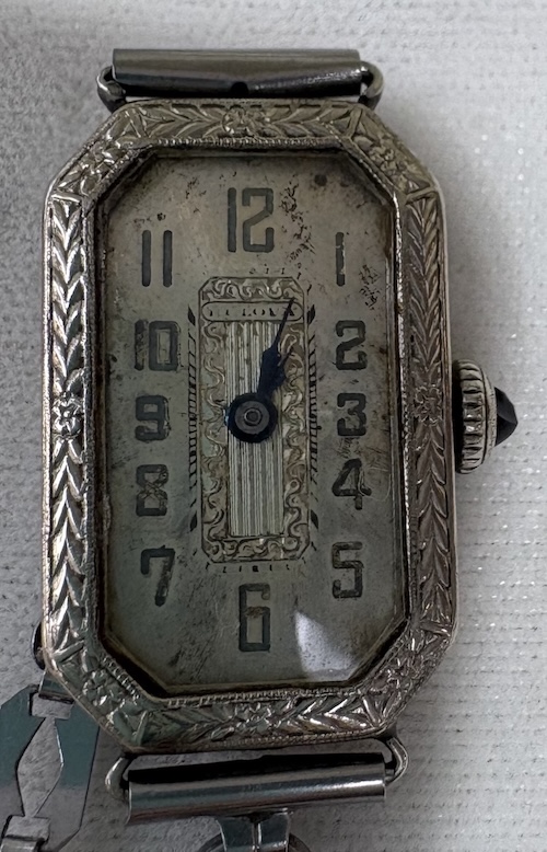 tall rectangle-shaped clock face with small dark blue hands