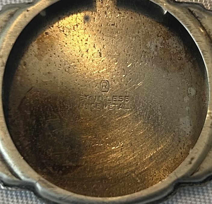 Inside caseback. Looks like something is written on lower portions but I can’t read it